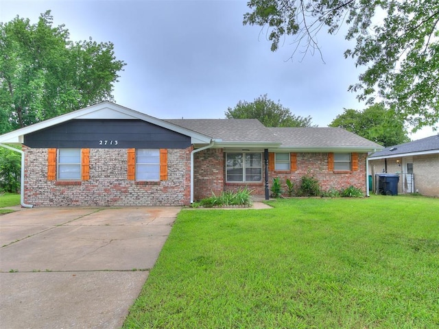 2713 SW 75th St, Oklahoma City, OK 73159 - ranch-style house with a front lawn, brick siding, and driveway