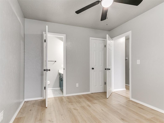 2713 SW 75th St, Oklahoma City, OK 73159 - unfurnished bedroom featuring light wood-type flooring, connected bathroom, and baseboards