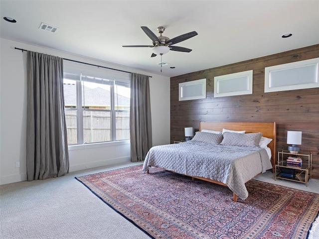 4304 NW 154th Pl, Edmond, OK 73013 - carpeted bedroom featuring wood walls and ceiling fan