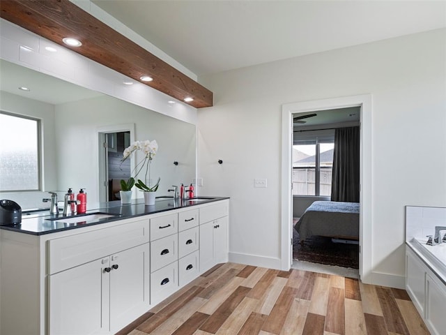 4304 NW 154th Pl, Edmond, OK 73013 - ensuite bathroom featuring double vanity, wood finished floors, a garden tub, and recessed lighting