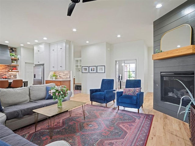 4304 NW 154th Pl, Edmond, OK 73013 - living room with ceiling fan, a fireplace, light wood-style floors, and recessed lighting