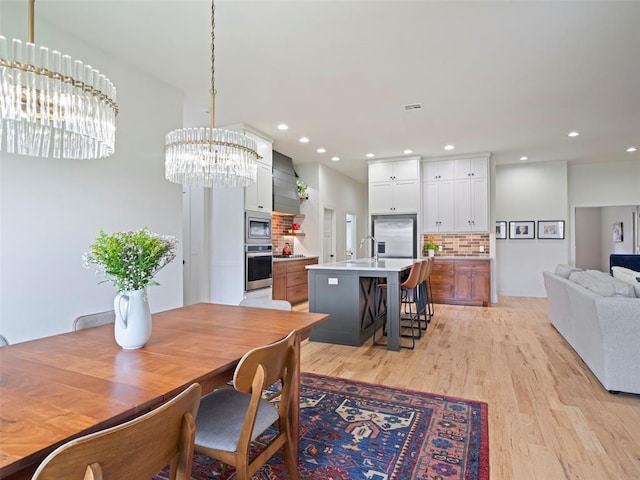 4304 NW 154th Pl, Edmond, OK 73013 - dining space featuring light wood-style flooring, a chandelier, and recessed lighting