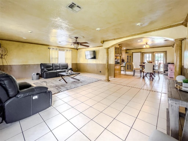 1117 SW 37th St, Oklahoma City, OK 73109 - living area with decorative columns, arched walkways, a ceiling fan, plenty of natural light, and crown molding