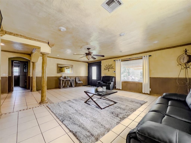 1117 SW 37th St, Oklahoma City, OK 73109 - living room with ornate columns, a wainscoted wall, crown molding, a ceiling fan, and light tile patterned floors