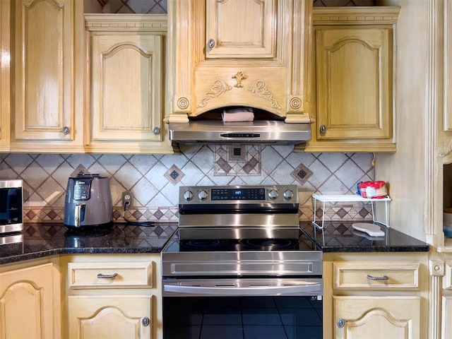 1117 SW 37th St, Oklahoma City, OK 73109 - kitchen with stainless steel electric stove, cream cabinets, tasteful backsplash, dark stone countertops, and tile patterned floors