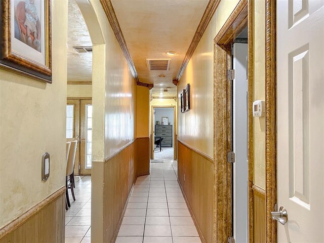 1117 SW 37th St, Oklahoma City, OK 73109 - hallway featuring crown molding, a wainscoted wall, and light tile patterned floors