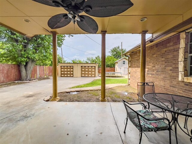 1117 SW 37th St, Oklahoma City, OK 73109 - view of patio / terrace featuring a trampoline, an outdoor structure, outdoor dining area, a garage, and driveway