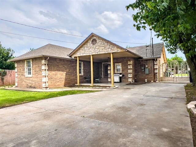 1117 SW 37th St, Oklahoma City, OK 73109 - view of front of home with brick siding, concrete driveway, and roof with shingles