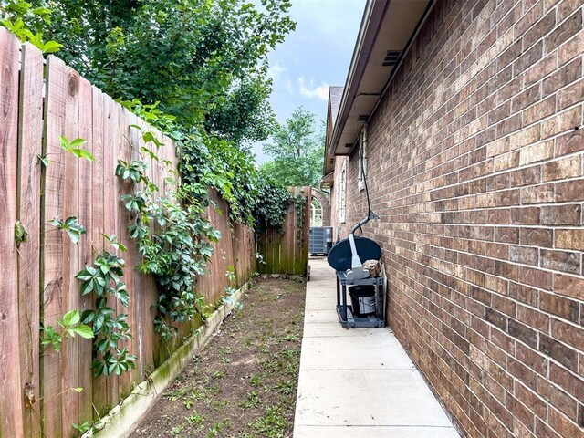 1117 SW 37th St, Oklahoma City, OK 73109 - view of side of home featuring brick siding and central AC