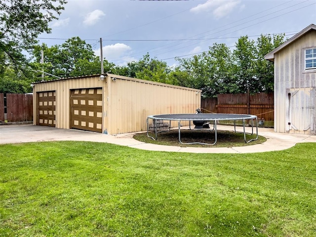 1117 SW 37th St, Oklahoma City, OK 73109 - view of yard with a trampoline, an outdoor structure, and a garage