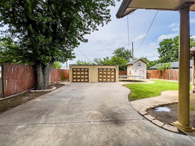 1117 SW 37th St, Oklahoma City, OK 73109 - view of patio featuring an outdoor structure, a detached garage, and a trampoline