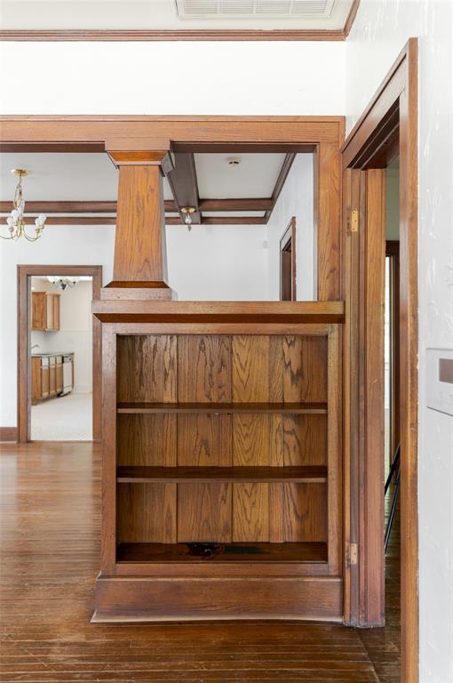 1505 NW 34th St, Oklahoma City, OK 73118 - detailed view of wood finished floors, crown molding, and a chandelier