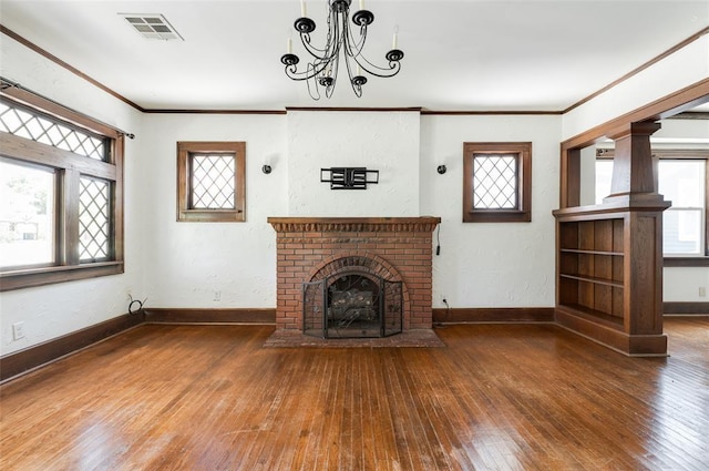 1505 NW 34th St, Oklahoma City, OK 73118 - unfurnished living room with hardwood / wood-style flooring, baseboards, crown molding, plenty of natural light, and a fireplace