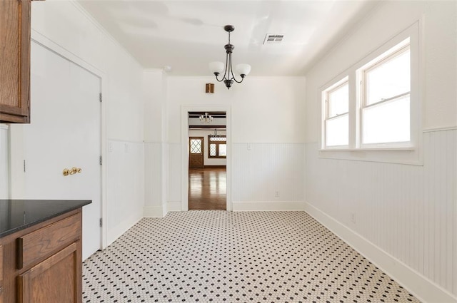1505 NW 34th St, Oklahoma City, OK 73118 - unfurnished dining area featuring a wainscoted wall, a chandelier, and ornamental molding