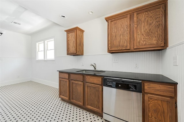 1505 NW 34th St, Oklahoma City, OK 73118 - kitchen featuring stainless steel dishwasher, a sink, dark countertops, a wainscoted wall, and brown cabinets