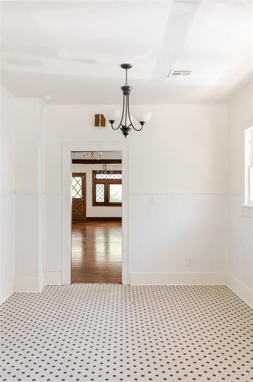 1505 NW 34th St, Oklahoma City, OK 73118 - spare room with a wainscoted wall and a chandelier