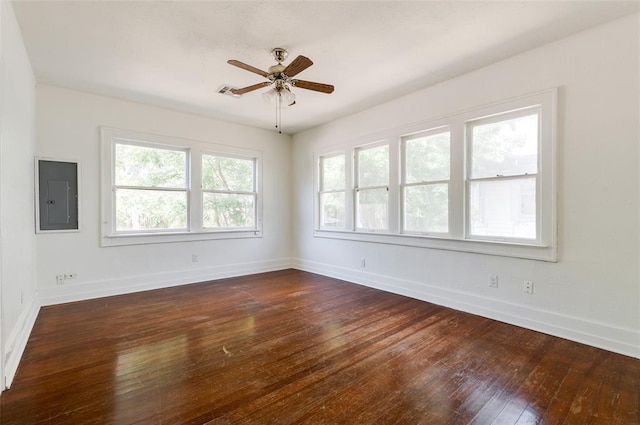 1505 NW 34th St, Oklahoma City, OK 73118 - spare room featuring electric panel, dark wood-style flooring, baseboards, and a ceiling fan