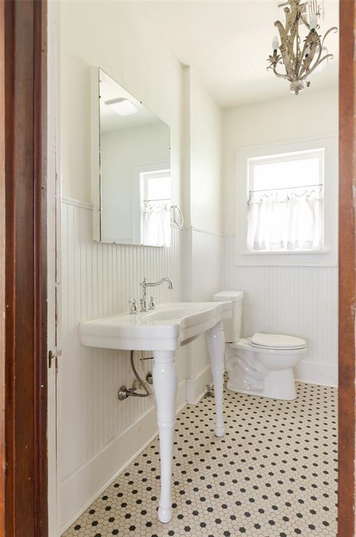 1505 NW 34th St, Oklahoma City, OK 73118 - bathroom with a wainscoted wall, a chandelier, and toilet
