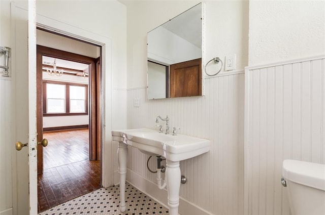 1505 NW 34th St, Oklahoma City, OK 73118 - bathroom featuring wainscoting, toilet, and wood finished floors