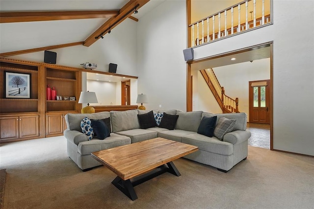 2108 Woodhill Rd, Edmond, OK 73025 - living room featuring light carpet, high vaulted ceiling, stairs, and beamed ceiling