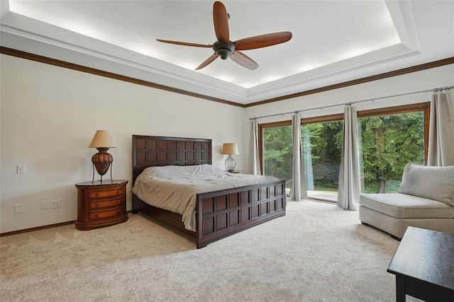 2108 Woodhill Rd, Edmond, OK 73025 - carpeted bedroom with a raised ceiling, access to outside, a ceiling fan, ornamental molding, and baseboards