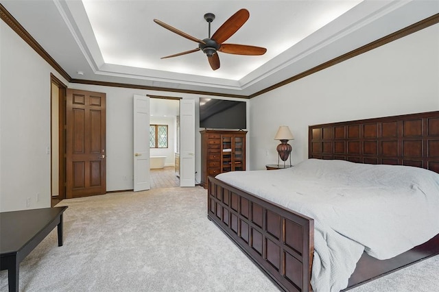 2108 Woodhill Rd, Edmond, OK 73025 - bedroom with a tray ceiling, crown molding, light colored carpet, connected bathroom, and ceiling fan