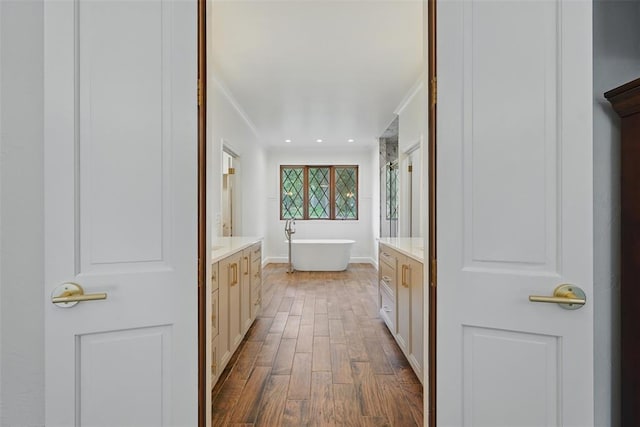 2108 Woodhill Rd, Edmond, OK 73025 - full bath with vanity, ornamental molding, wood finished floors, a soaking tub, and a shower