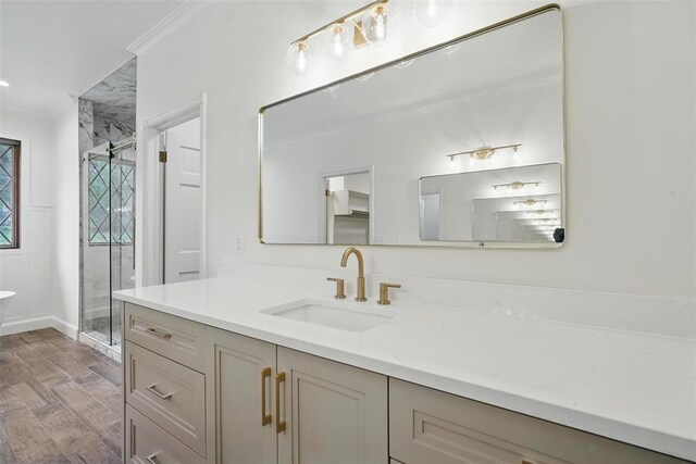2108 Woodhill Rd, Edmond, OK 73025 - full bath featuring vanity, a stall shower, wood finished floors, crown molding, and a freestanding tub
