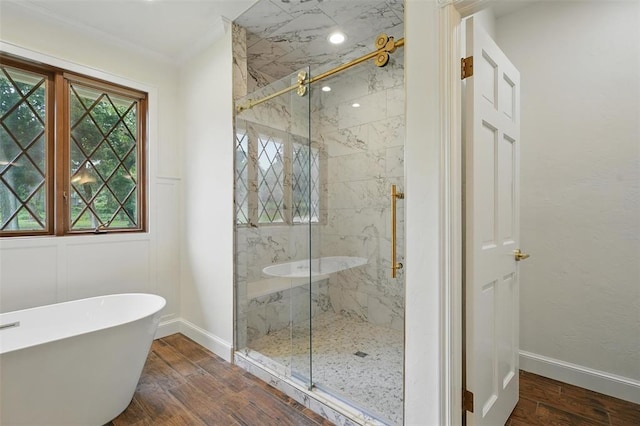 2108 Woodhill Rd, Edmond, OK 73025 - bathroom featuring a marble finish shower, a soaking tub, wood finished floors, baseboards, and ornamental molding
