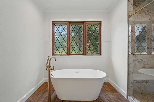 2108 Woodhill Rd, Edmond, OK 73025 - full bath with a soaking tub, wood finished floors, baseboards, and crown molding