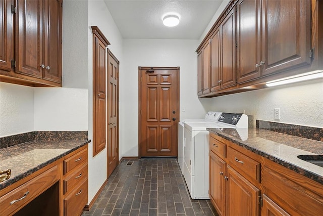 2108 Woodhill Rd, Edmond, OK 73025 - laundry area featuring cabinet space, washing machine and clothes dryer, brick patterned floors, and baseboards
