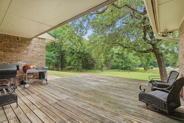 2108 Woodhill Rd, Edmond, OK 73025 - deck with a lawn, view of wooded area, and area for grilling