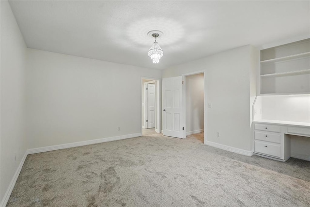 2108 Woodhill Rd, Edmond, OK 73025 - unfurnished bedroom featuring carpet floors, baseboards, a chandelier, and a desk
