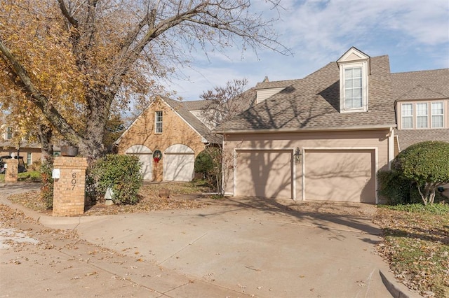 607 Aberdeen Rd, Edmond, OK 73025 - view of front of house with concrete driveway, a shingled roof, and an attached garage
