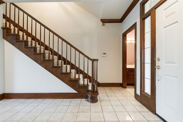 607 Aberdeen Rd, Edmond, OK 73025 - foyer with baseboards, stairs, and crown molding