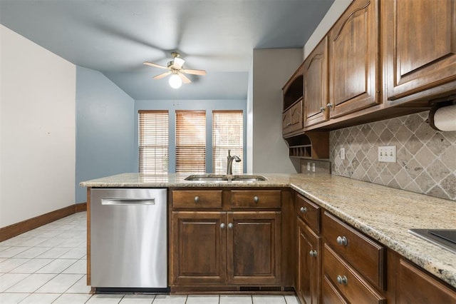 607 Aberdeen Rd, Edmond, OK 73025 - kitchen with stainless steel dishwasher, a sink, a peninsula, decorative backsplash, and ceiling fan