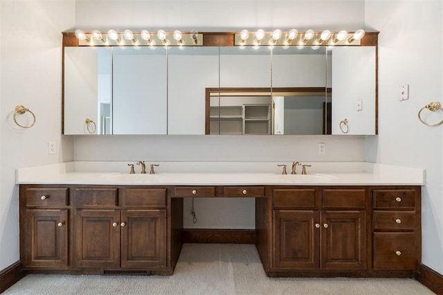 607 Aberdeen Rd, Edmond, OK 73025 - bathroom with double vanity and baseboards