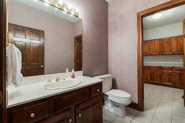 607 Aberdeen Rd, Edmond, OK 73025 - bathroom featuring vanity, toilet, and tile patterned flooring