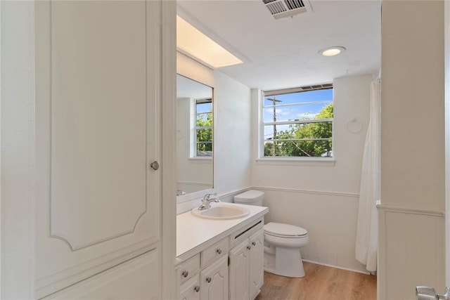 1121 NW 105th St, Oklahoma City, OK 73114 - bathroom with vanity, wood finished floors, and a shower with curtain
