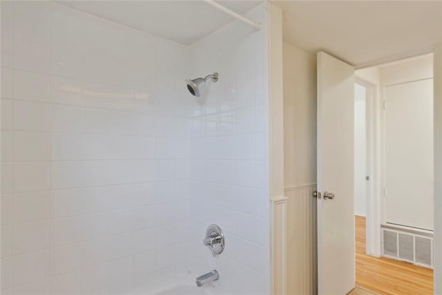 1121 NW 105th St, Oklahoma City, OK 73114 - bathroom with shower / bath combination and wood finished floors