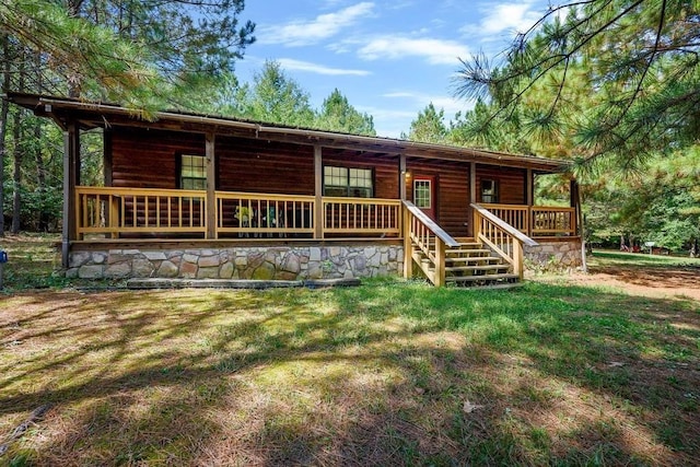 657 Canoe Rd, Broken Bow, OK 74728 - view of front facade with a porch, a front yard, and log veneer siding