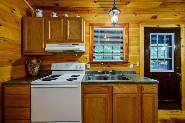 657 Canoe Rd, Broken Bow, OK 74728 - kitchen featuring under cabinet range hood, white range with electric cooktop, a sink, dark countertops, and healthy amount of natural light