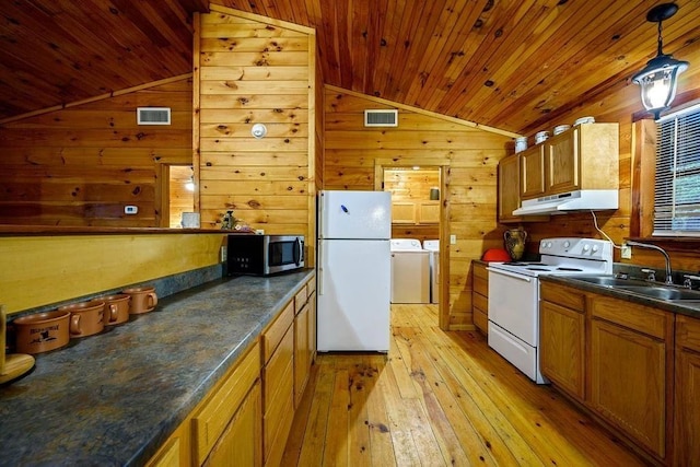 657 Canoe Rd, Broken Bow, OK 74728 - kitchen featuring white appliances, lofted ceiling, washing machine and clothes dryer, under cabinet range hood, and dark countertops
