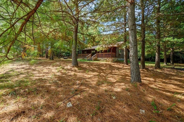 657 Canoe Rd, Broken Bow, OK 74728 - view of yard featuring a porch and stairs