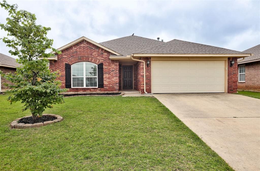 4218 Syracuse St, Moore, OK 73160 - ranch-style house featuring brick siding, driveway, a garage, a front lawn, and roof with shingles