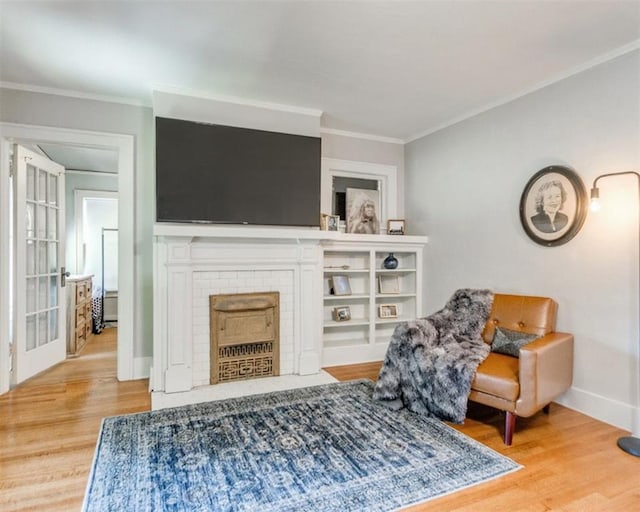 1218 NW 21st St, Oklahoma City, OK 73106 - living room with wood finished floors, crown molding, baseboards, and a fireplace