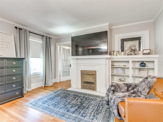 1218 NW 21st St, Oklahoma City, OK 73106 - living area featuring wood finished floors, a brick fireplace, ornamental molding, and baseboards
