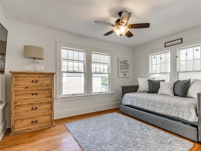 1218 NW 21st St, Oklahoma City, OK 73106 - bedroom with baseboards, light wood finished floors, and a ceiling fan