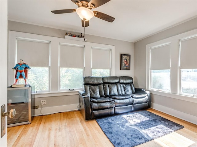 1218 NW 21st St, Oklahoma City, OK 73106 - living area featuring plenty of natural light, wood finished floors, ceiling fan, baseboards, and crown molding