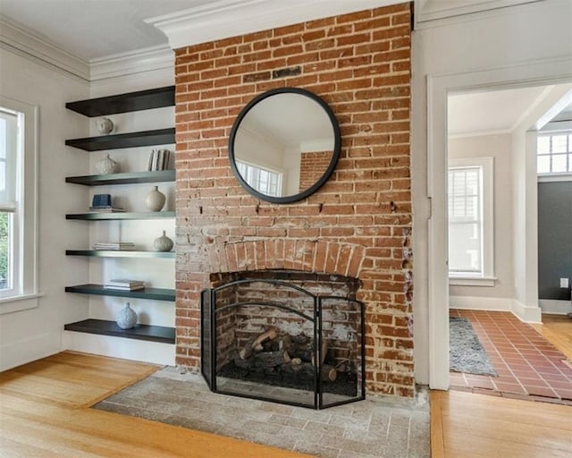 1218 NW 21st St, Oklahoma City, OK 73106 - detailed view of wood finished floors, crown molding, a brick fireplace, and baseboards